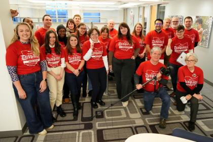 Photo of smiling workers in red union t-shirts.